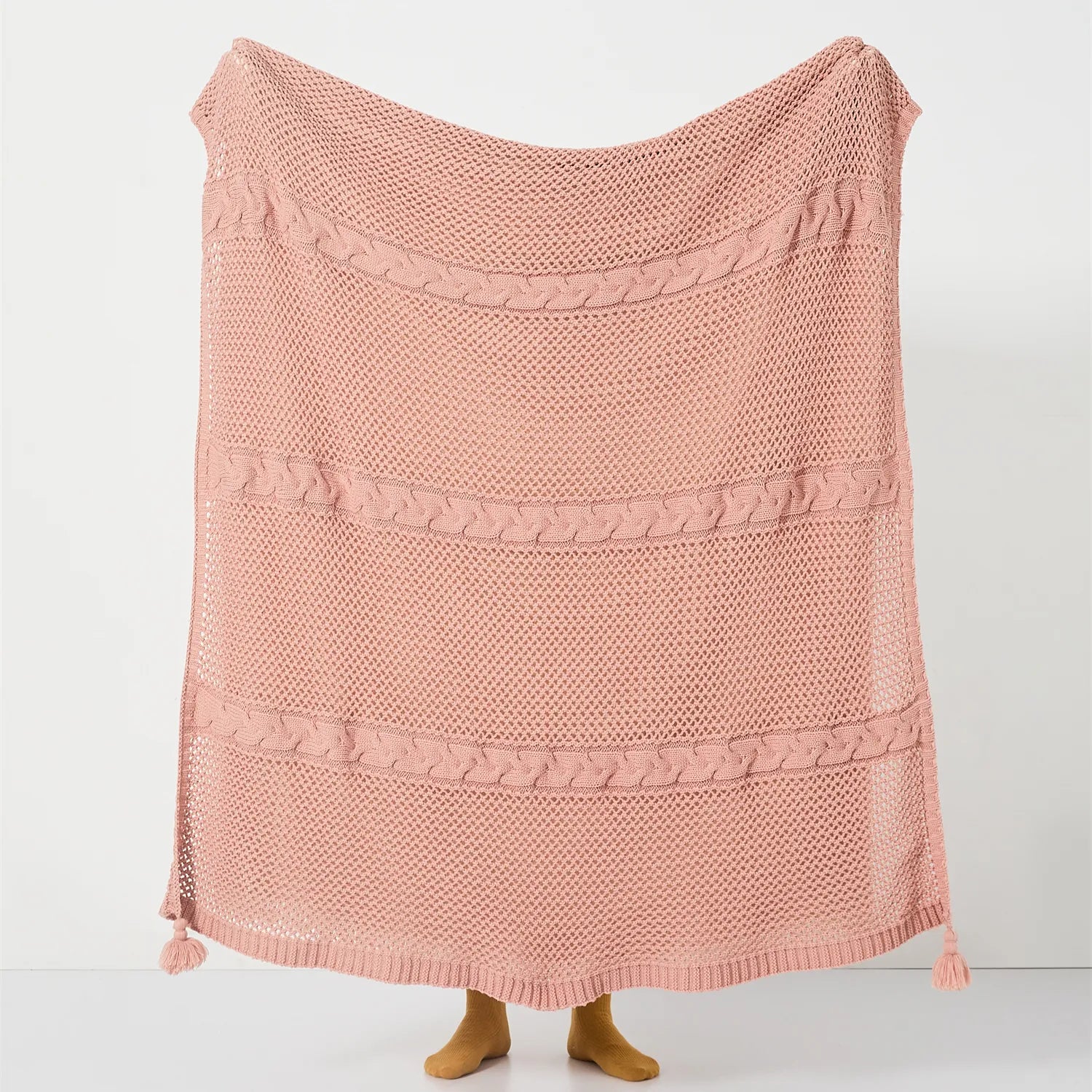 Person Holding Up Rose Pink Throw Blanket with Cable Knit Texture