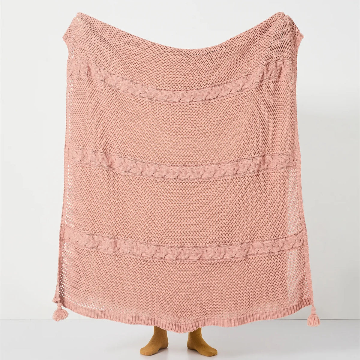Person Holding Up Rose Pink Throw Blanket with Cable Knit Texture