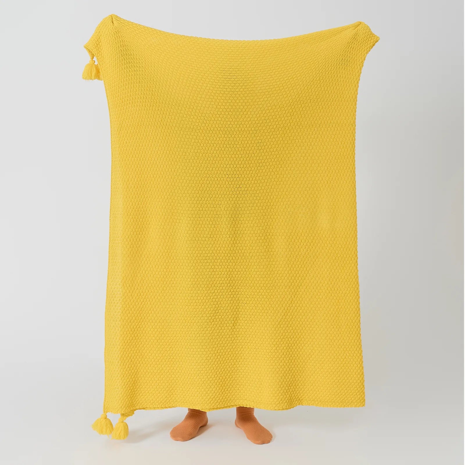 Person Holding Up Sunny Yellow Knitted Throw Blanket Full Length