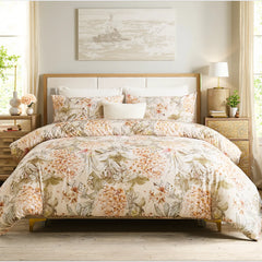 Hydrangea floral duvet cover set spread on bed with soft yellow background