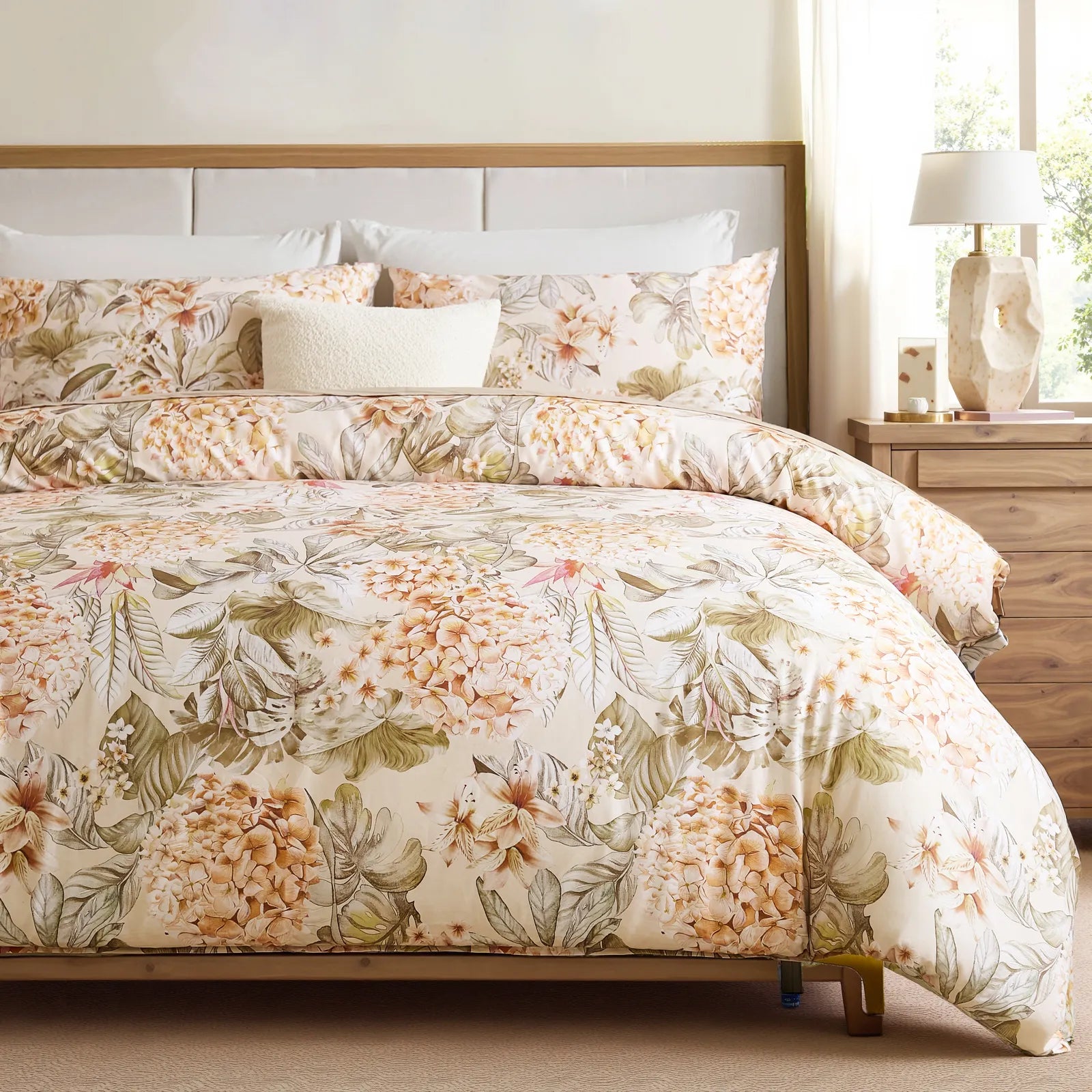 Hydrangea and lily floral comforter set styled in a bright, modern bedroom