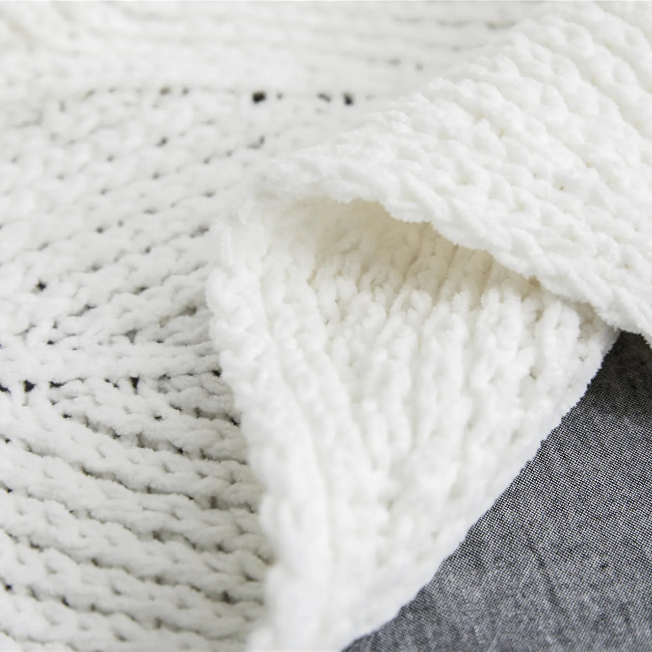 Close up of ivory white chunky knit texture showing detailed weave