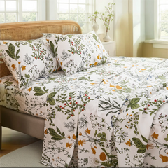 Close angled shot of Lush Botanical cotton sateen pillows and fitted sheet