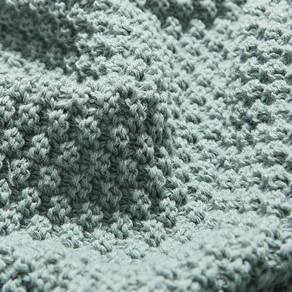 Macro Close-up of Aqua Knitted Fabric Texture and Weave Pattern