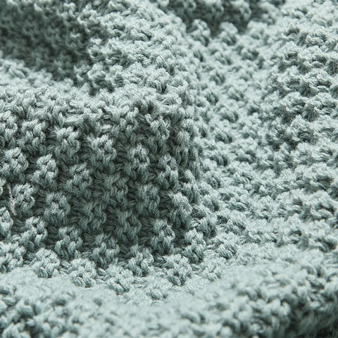 Macro Close-up of Aqua Knitted Fabric Texture and Weave Pattern