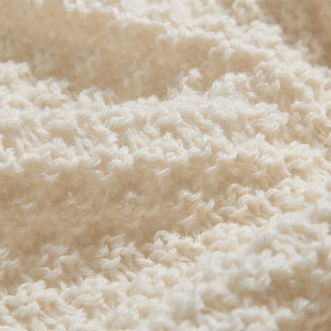 Macro Close-up of Beige Knitted Fabric Texture and Weave