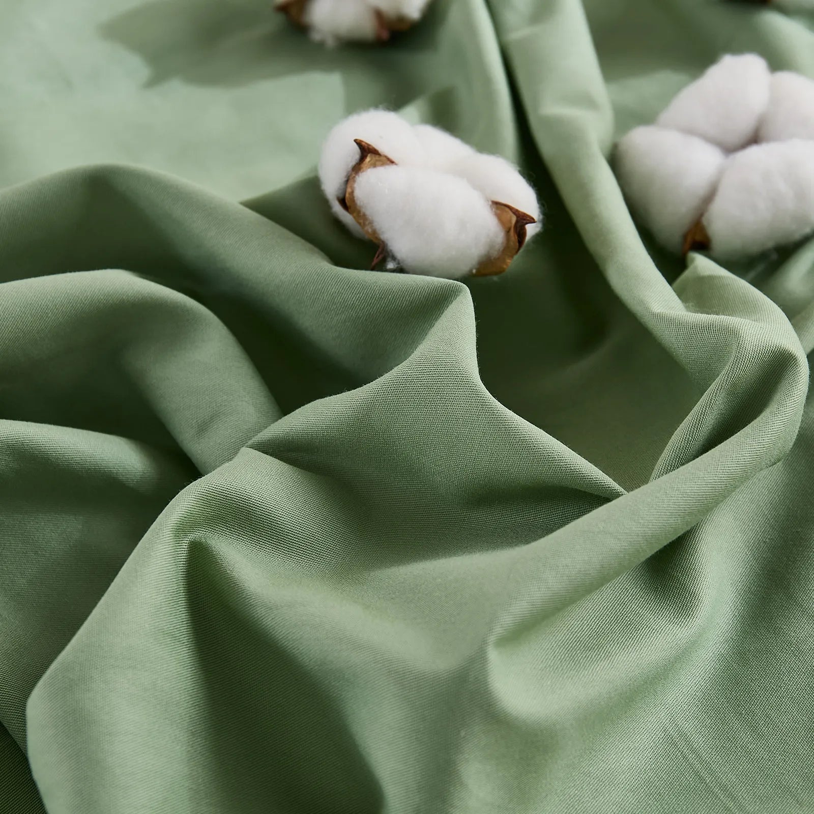 Matcha green duvet fabric texture close-up with cotton details