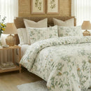 sage green botanical duvet cover styled with warm lighting and rustic bedroom decor