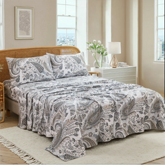 Close up detail of cotton neutral paisley print pillowcases and fitted sheet set