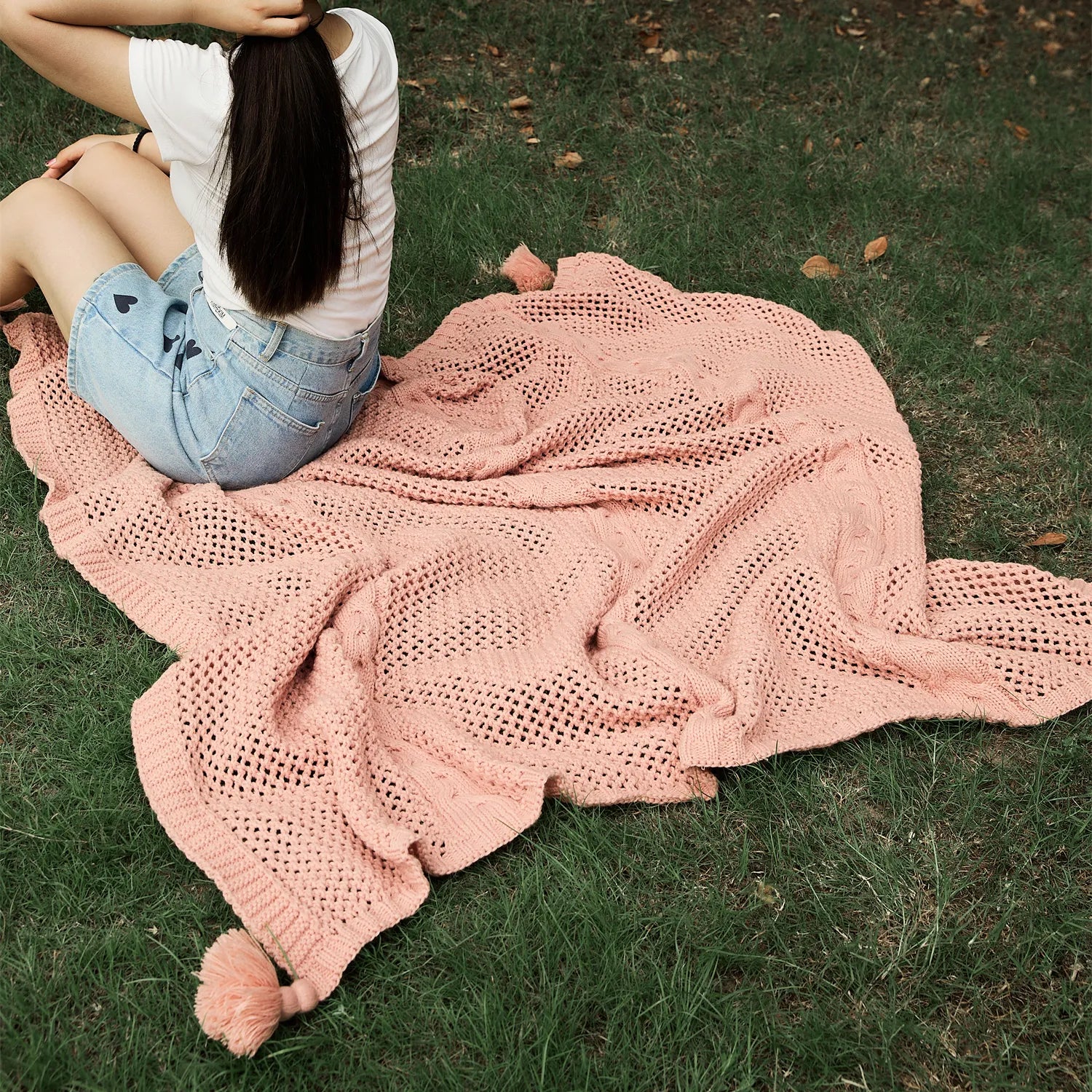 Outdoor Picnic Scene with Rose Pink Throw Blanket on Grass
