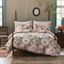 moody oil painting floral bedding in vintage bedroom with dark wood nightstand