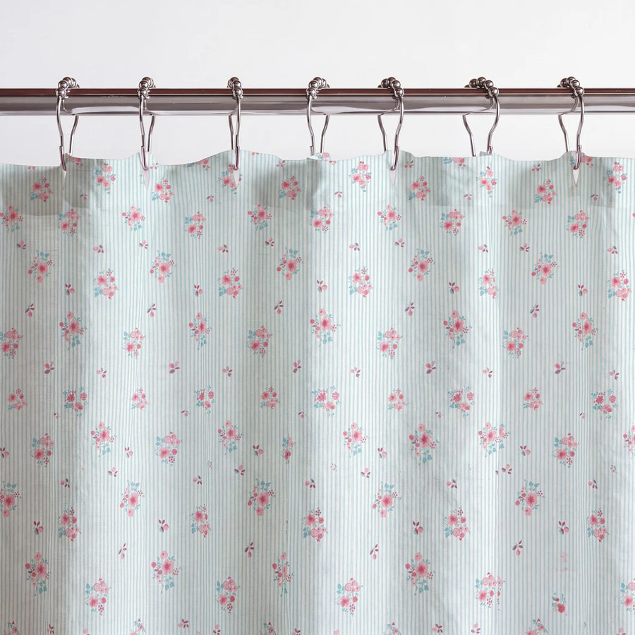 petite bloom pinstripe shower curtain blue pink metal rings close up