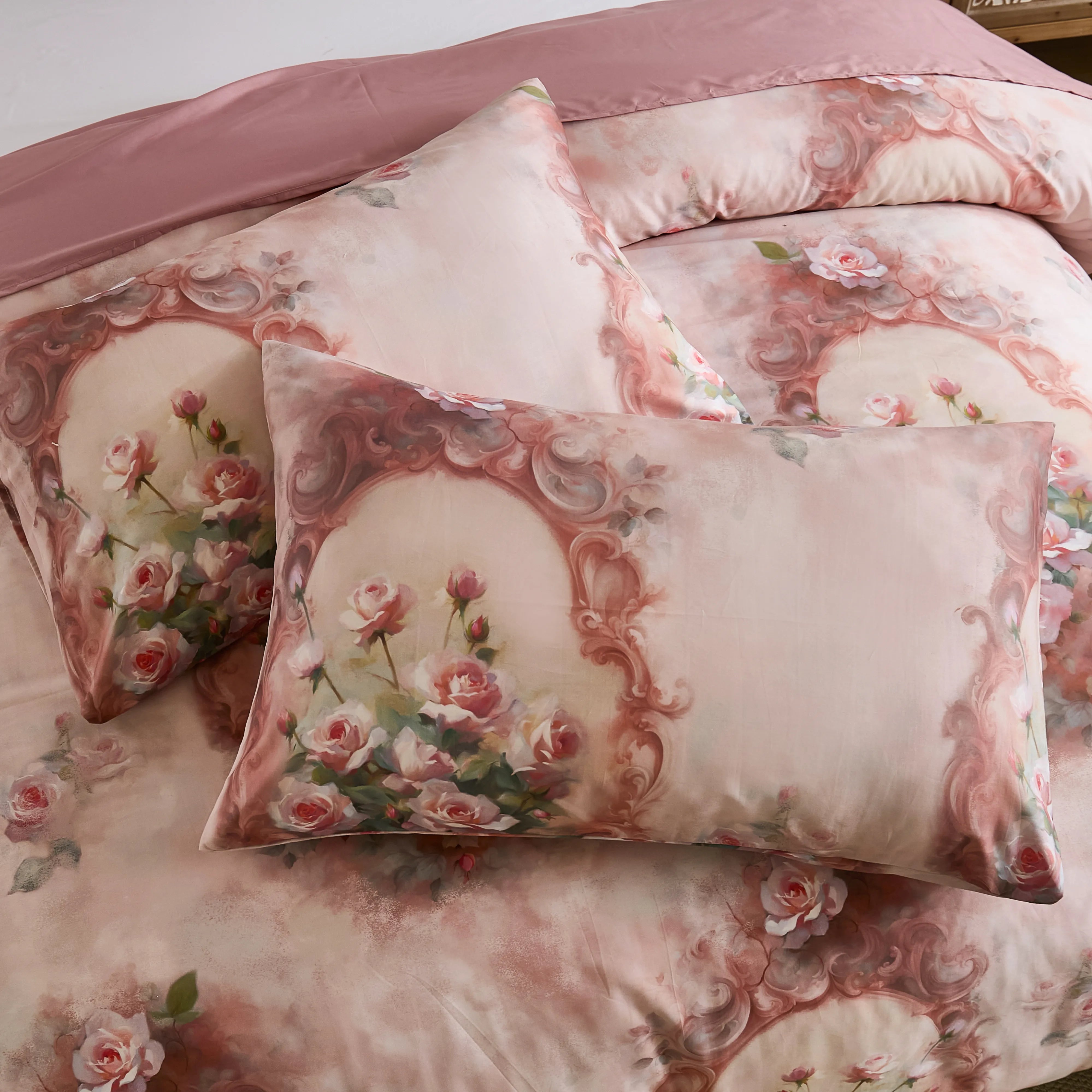 Top-down detail of the pink comforter set and matching pillows