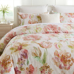 Close-up of the pink floral comforter and pillows on the bed