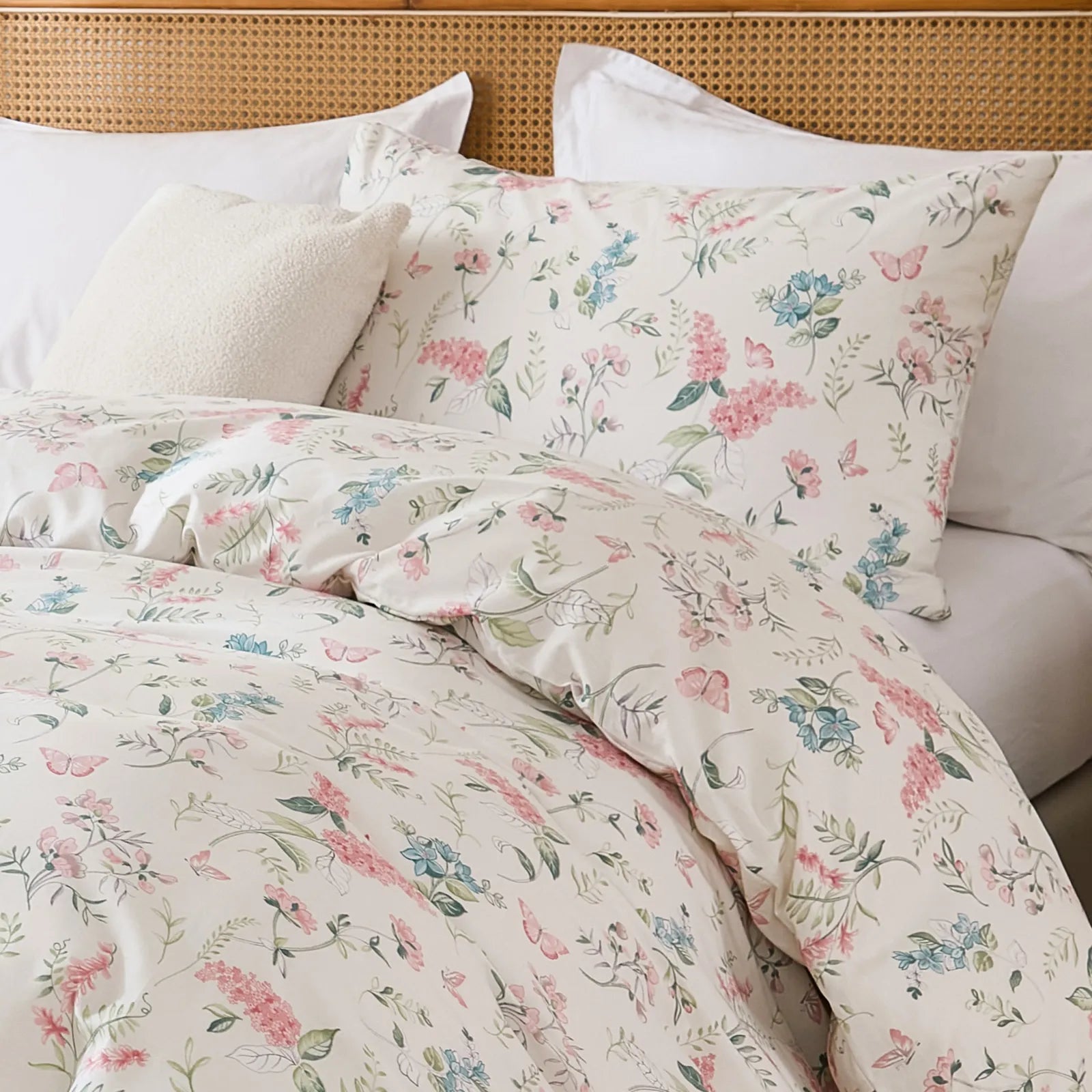 A detailed shot of the pink floral duvet cover from a bed corner angle