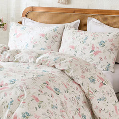 Close-up of the pink floral duvet cover on a bed, showing the pattern and texture