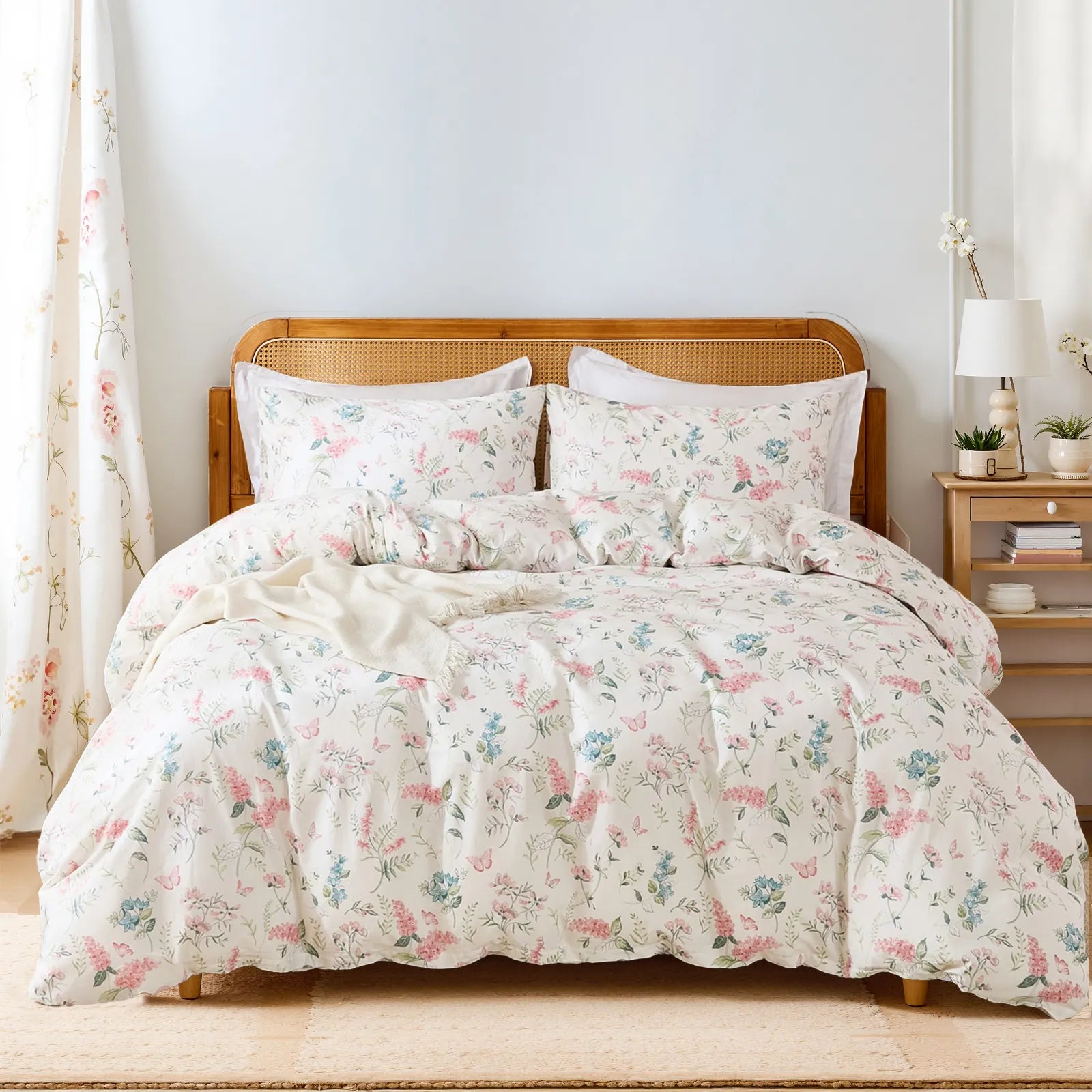 Full view of the pink floral duvet cover set styled on a bed