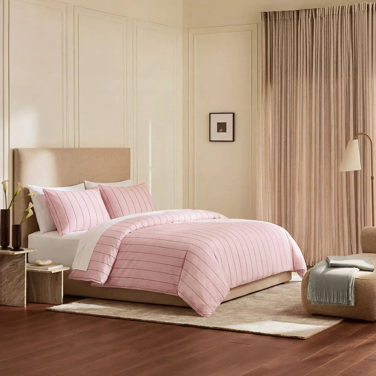 Angled shot of pink striped duvet cover on bed