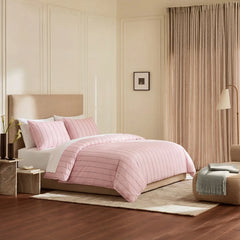 Angled shot of pink striped duvet cover on bed