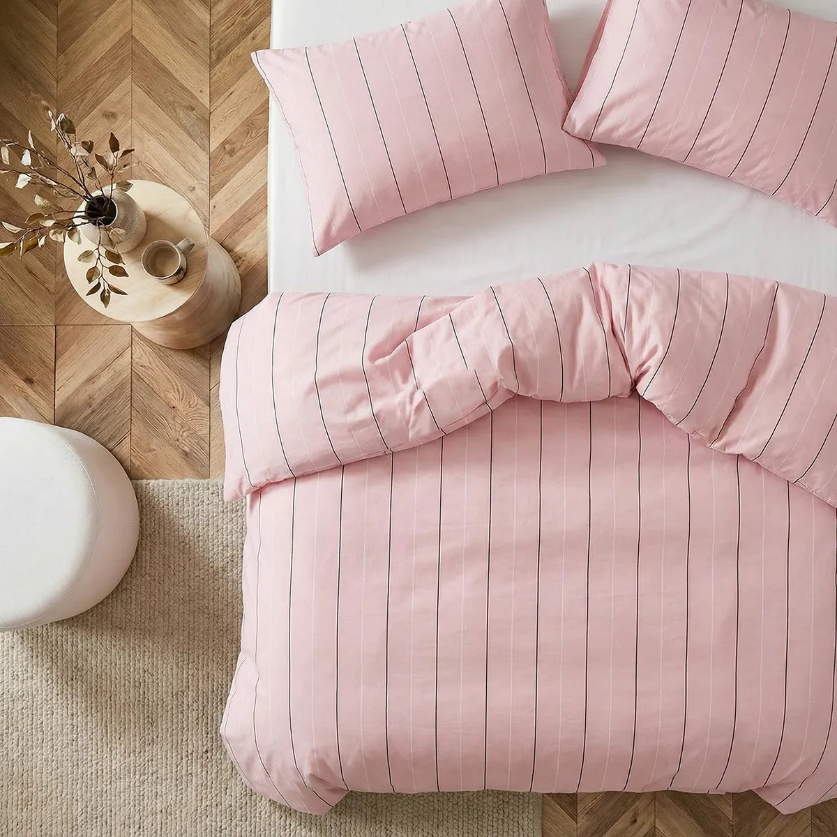 Overhead flat lay of pink striped duvet and cases