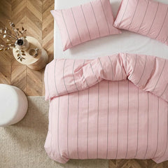 Overhead flat lay of pink striped duvet and cases