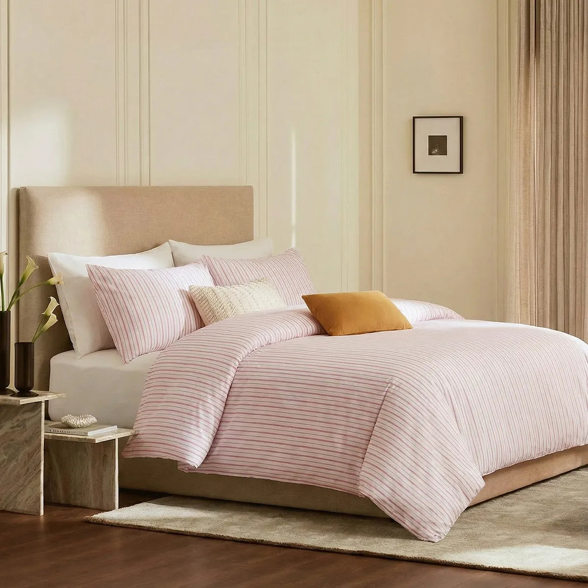 Angled shot of pink and white striped duvet cover on bed