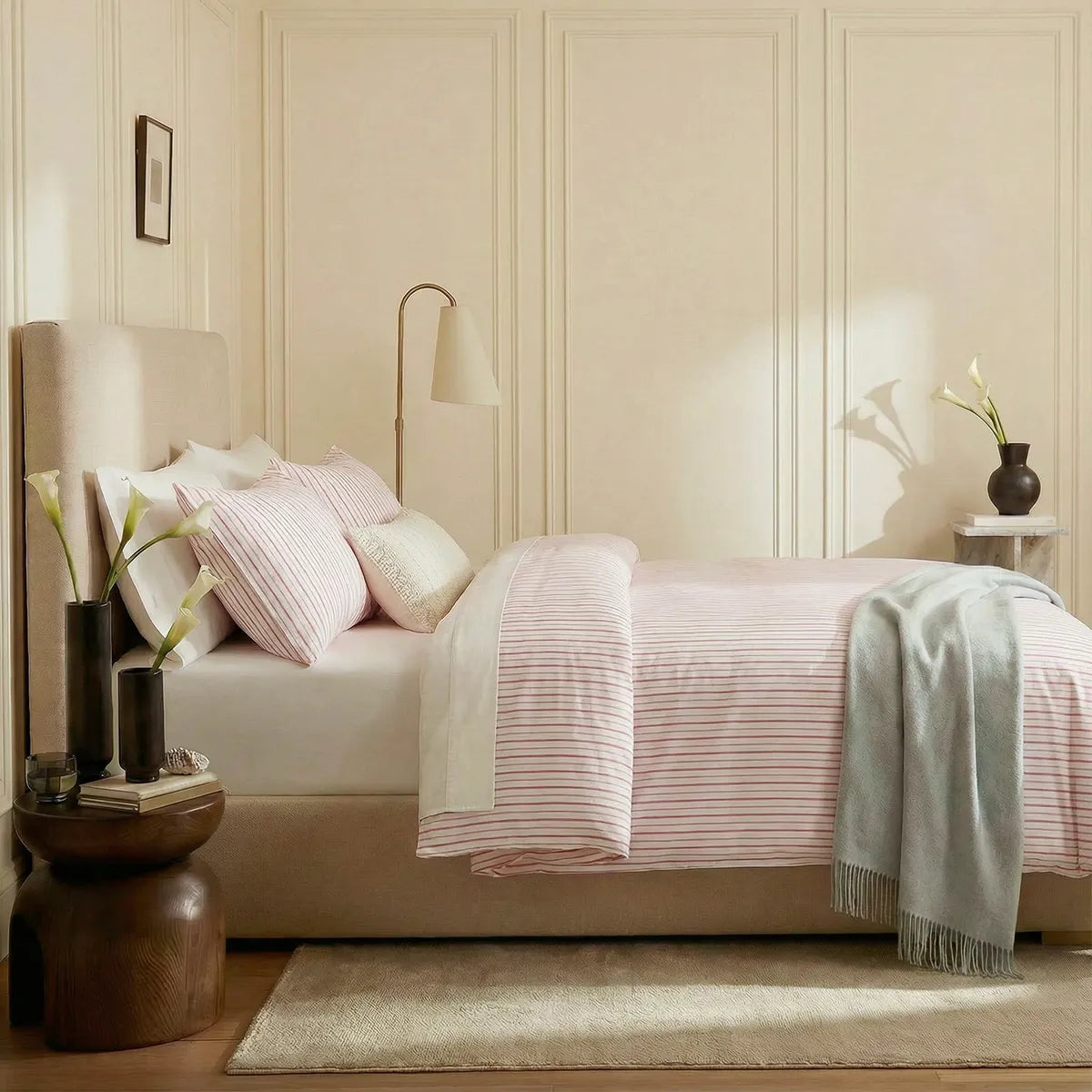 Side view of pink and white  striped duvet and pillows