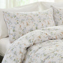 macro view of peach and blue wildflower sprig pattern on 100 percent premium cotton fabric