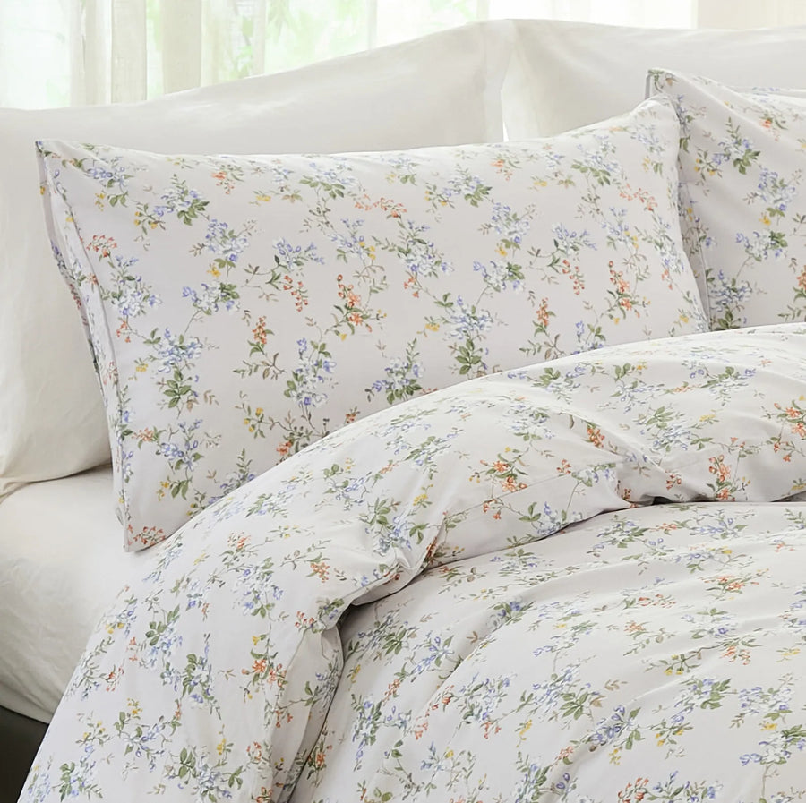 macro view of peach and blue wildflower sprig pattern on 100 percent premium cotton fabric