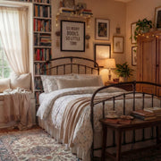 angled view of poetic meadow wildflower bedding in a nostalgic room with warm lighting and antique rugs
