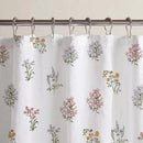 pressed botanical shower curtain white multicolor metal rings close up