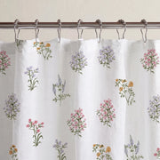 pressed botanical shower curtain white multicolor metal rings close up