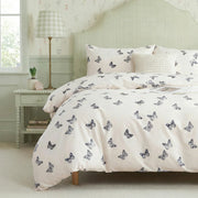 shabby chic butterfly print bedding set in cottagecore aesthetic bedroom with light green walls