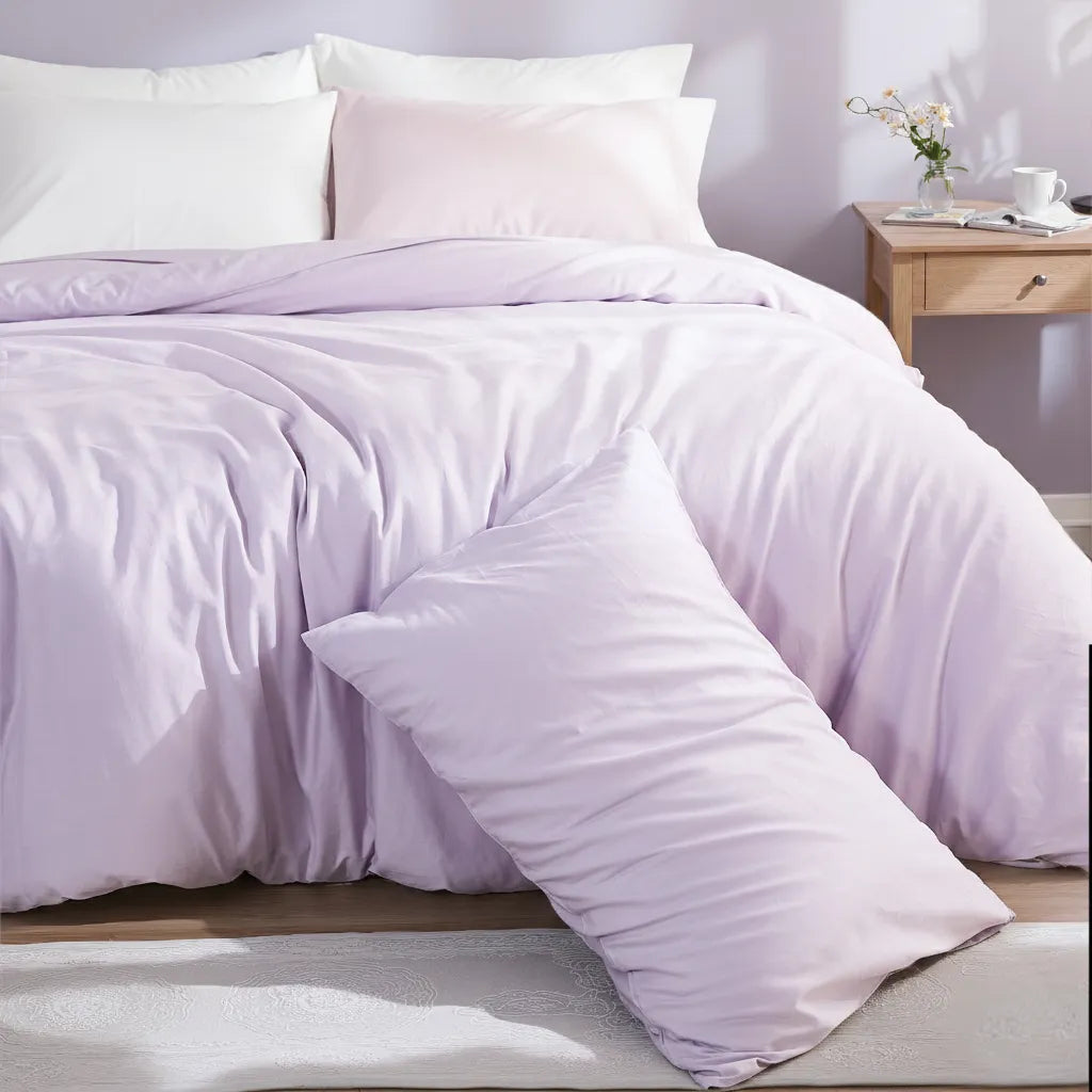 Purple cotton duvet set with a diagonally placed long pillow on a patterned carpet, creating a modern monochromatic style.