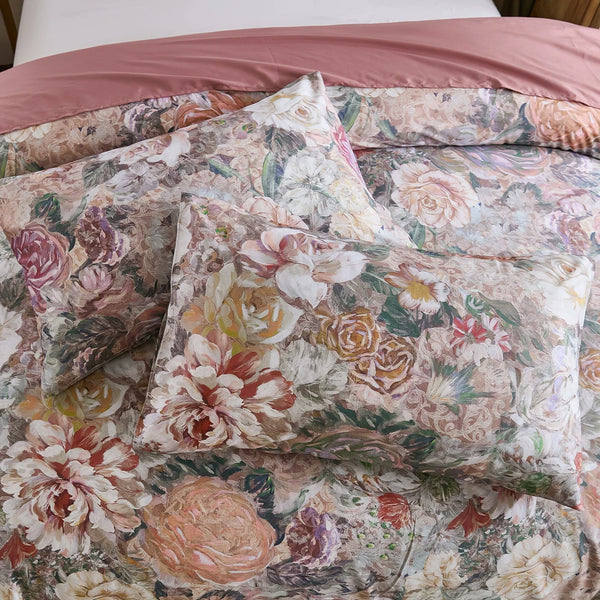 overhead flat lay shot of the moody rose and amber floral print on pillows and duvet set