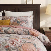 detailed view of oil-painting style floral print on cotton pillows and duvet cover
