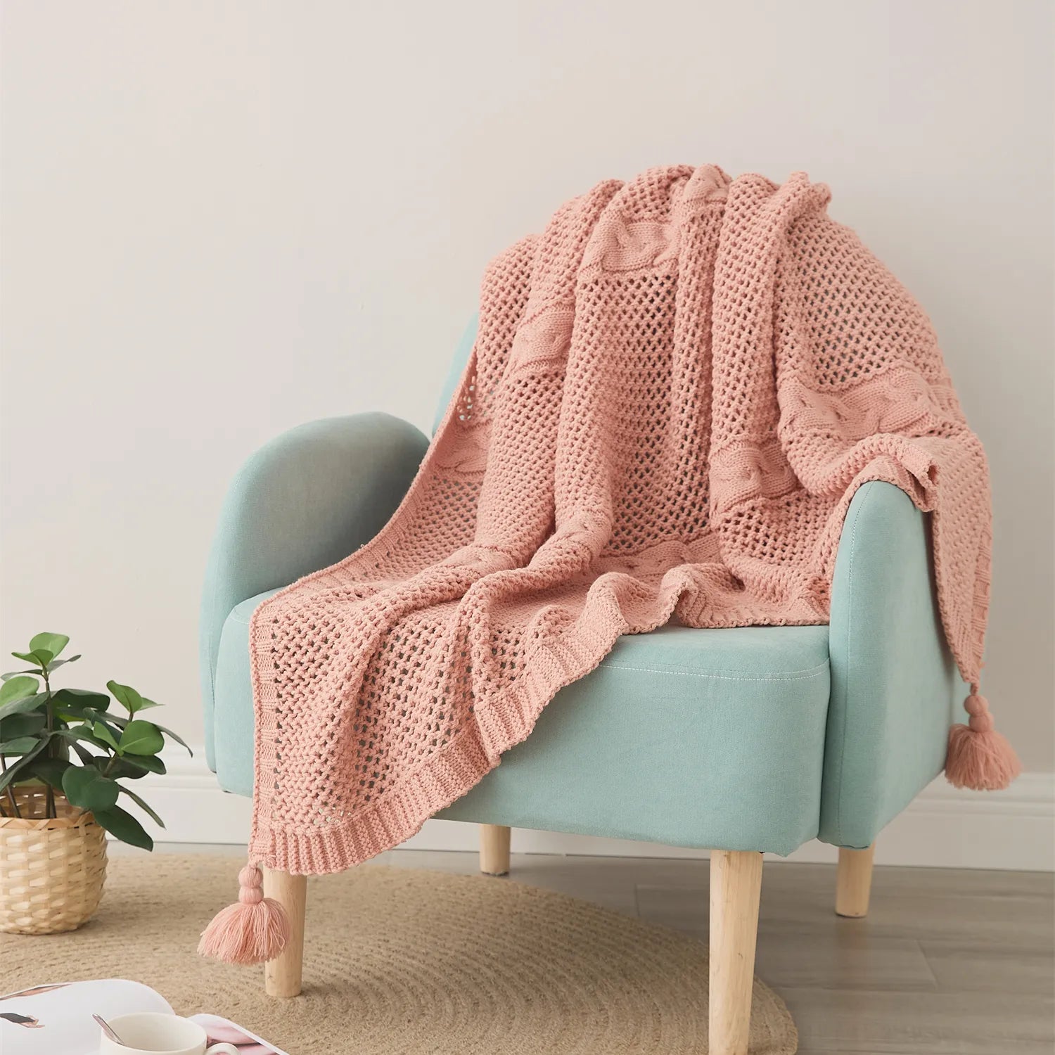 Rose Pink Throw Blanket on Teal Accent Chair with Plant Decor