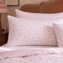 rosewick garden floral pillowcases blush pink botanical print rattan bedroom closeup