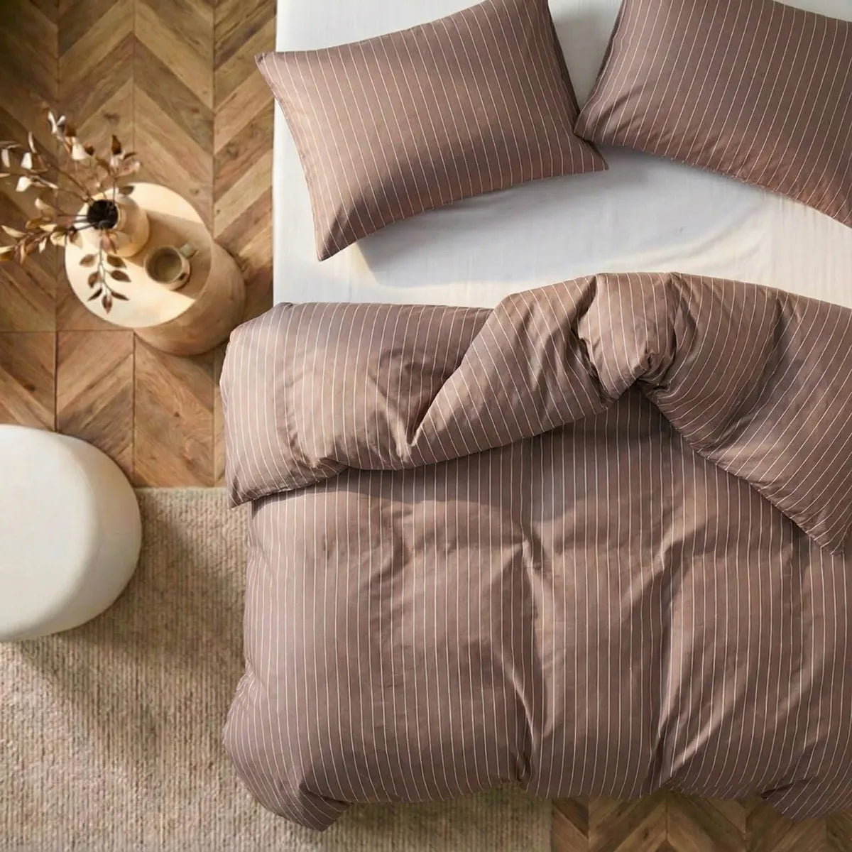 Overhead flat lay of rust red striped duvet and cases