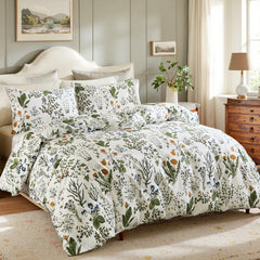 Angled view of a bed with a white comforter and pillows with a botanical floral pattern.