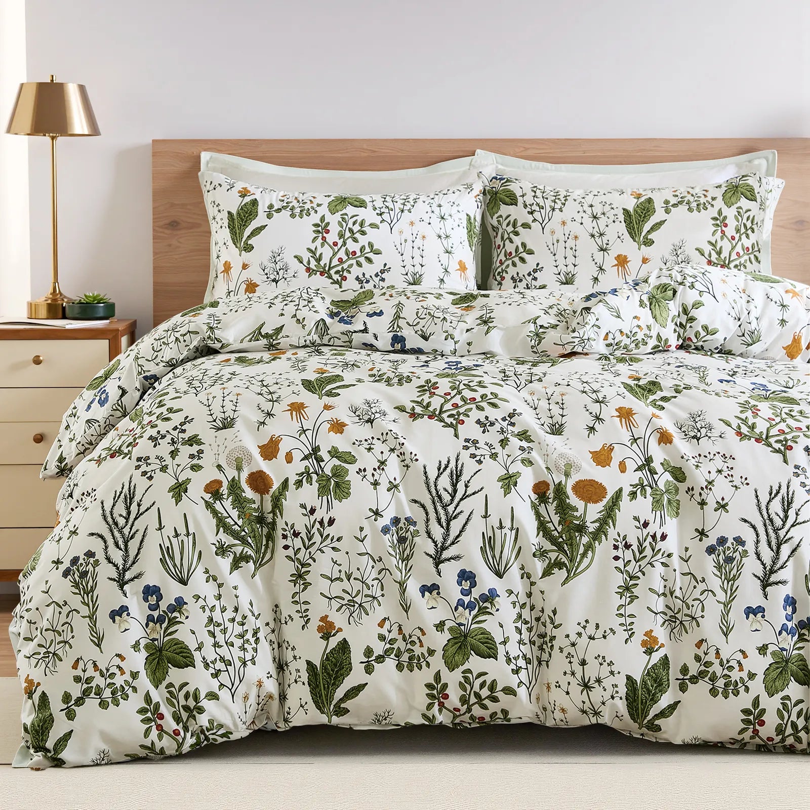 A full view of the sage green floral duvet cover set styled on a bed.