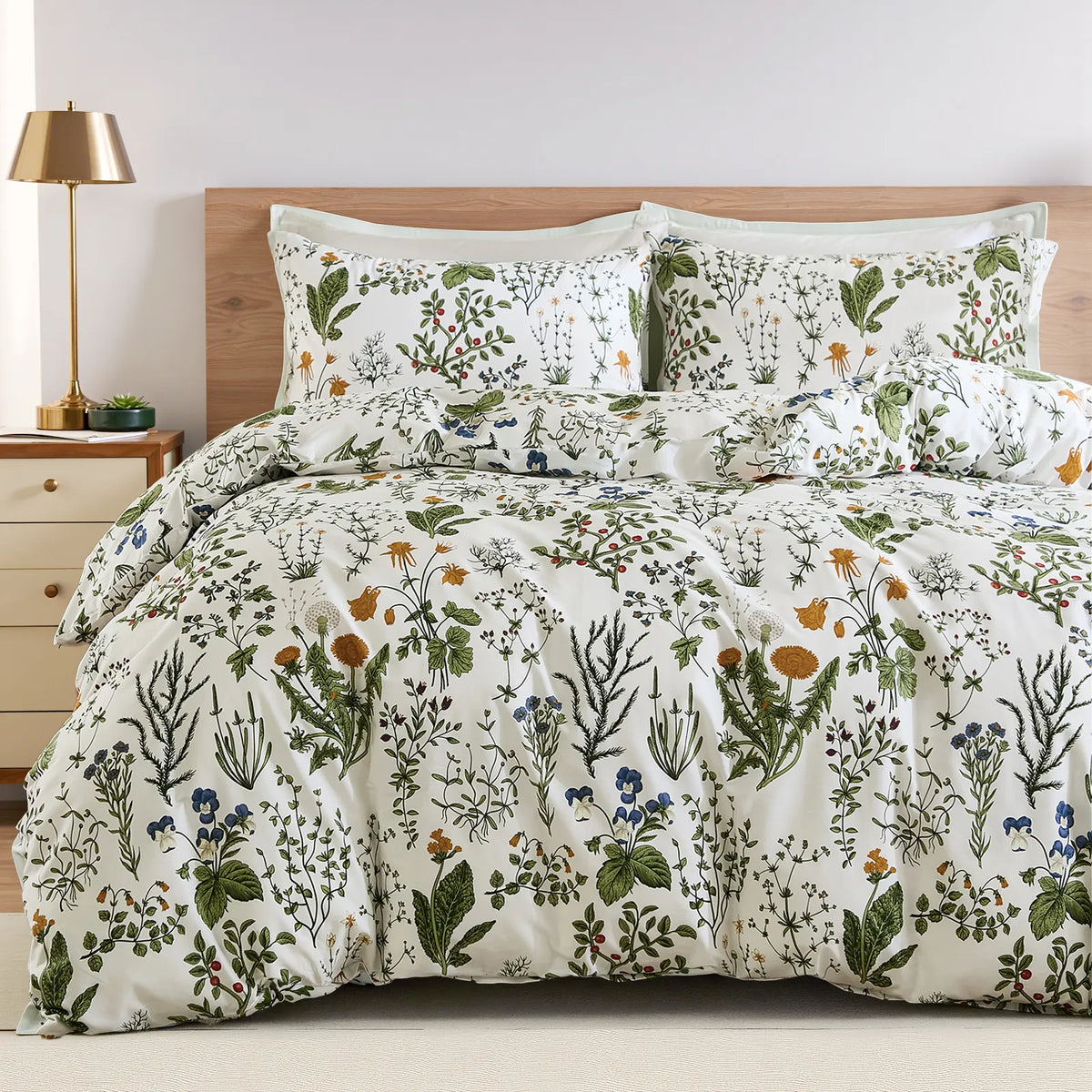 A full view of the sage green floral duvet cover set styled on a bed.