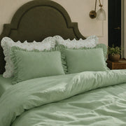 sage green ruffled pillow shams with floral accents