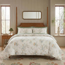 sanctuary meadow bloom duvet cover set styled on bed with wooden four-poster frame cottage bedroom