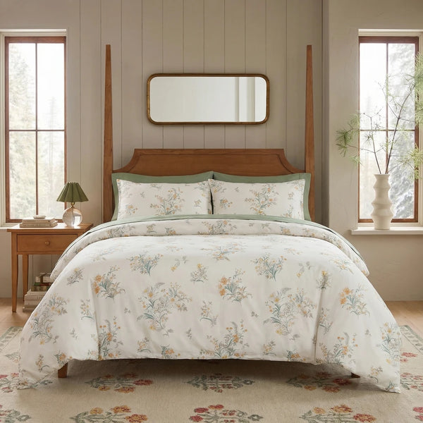 sanctuary meadow bloom duvet cover set styled on bed with wooden four-poster frame cottage bedroom