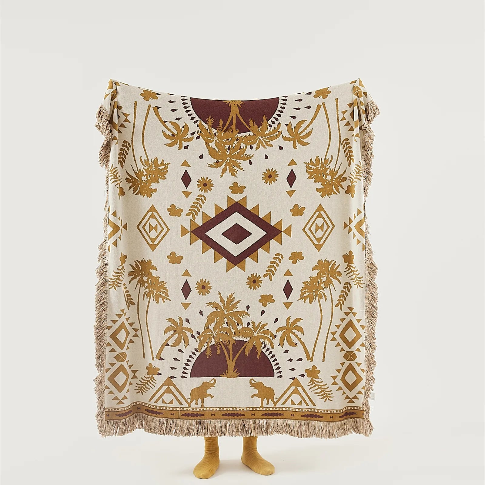 A full view of the sand yellow bohemian blanket, spread out to show its elegant, eye-catching pattern.