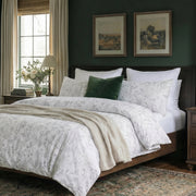 minimalist grey and white botanical bedding set in a bright airy room with rustic wooden bed
