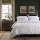 serene charcoal leaf duvet cover set styled on bed with minimalist grey botanical print on white