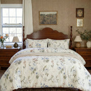 full bedroom scene featuring the blue botanical duvet set with traditional wallpaper and dresser