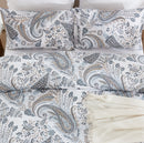 overhead flat lay shot of the coastal heritage paisley duvet set with a cream fringe throw
